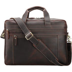 Brown leather briefcase with a shoulder strap on a white background